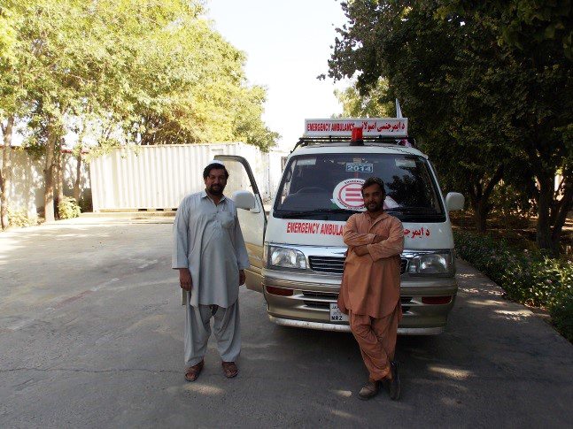 Aziz and Nabi near an EMERGENCY ambulance