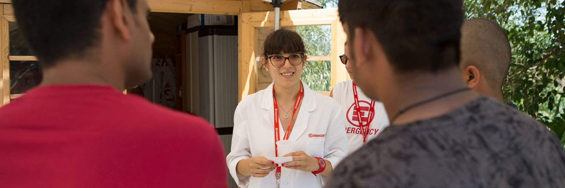 In Siciliy, an EMERGENCY doctors with two migrants