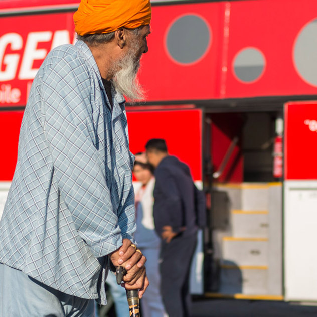 Outside one of EMERGENCY's Mobile Clinics, an old man waits for his turn to be visited