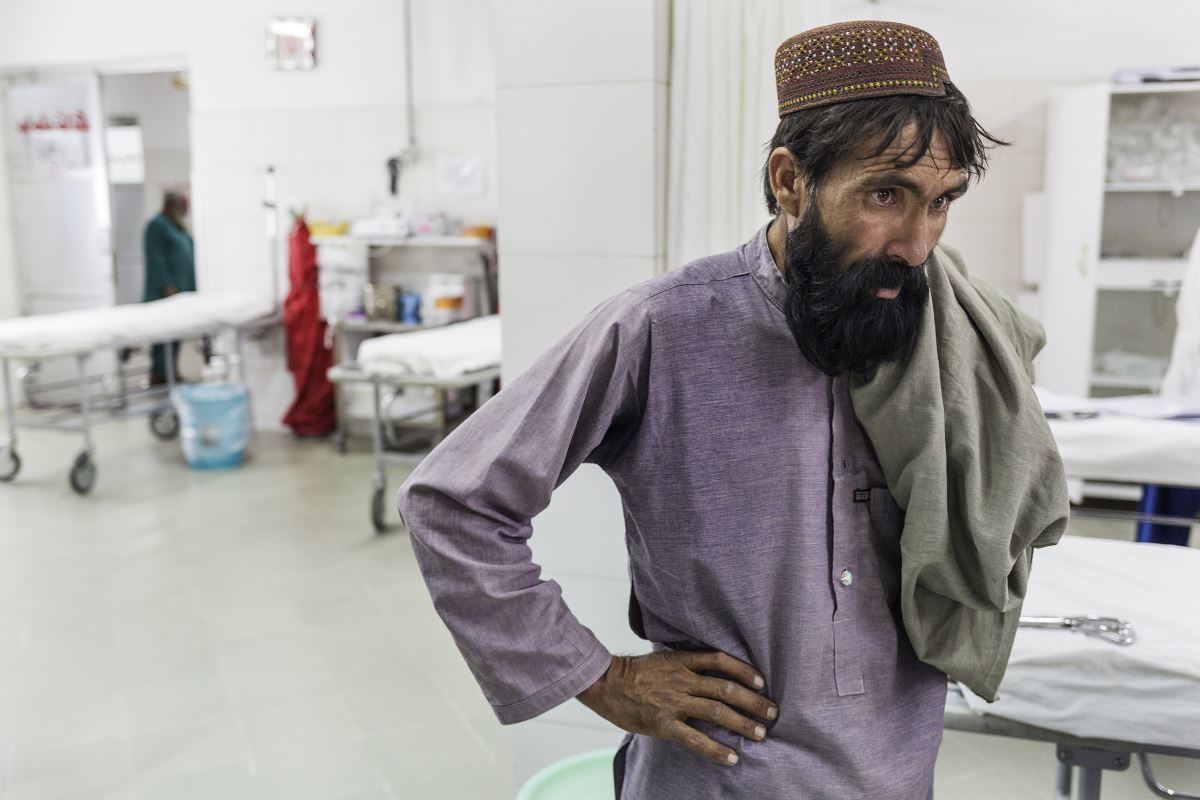 Khudai Noor's father watching the medical staff helping his son