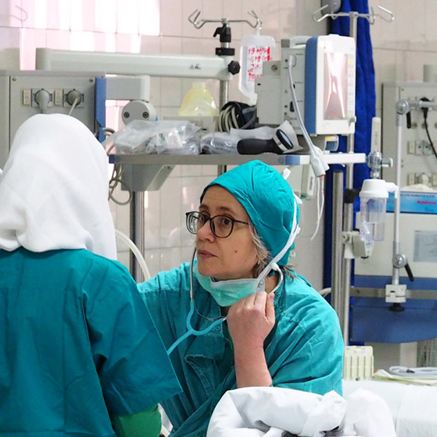 Staff visiting a patient in the ICU of the Salam Centre for Cardiac Surgery, Khartoum